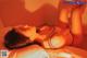 A woman laying on top of a bed in a red room.