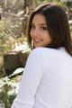 A woman in a white shirt posing for a picture.