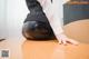 A woman sitting on top of a wooden table.