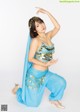 A woman in a blue belly dance outfit posing for a picture.